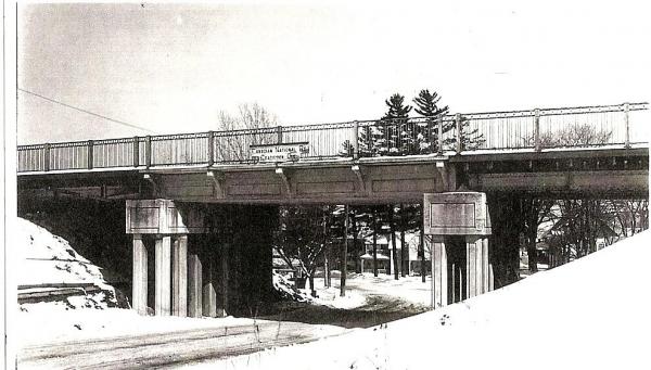 The bridge crossing over the Main Street West crosses the Canadian National train. This building dates back to 1939.